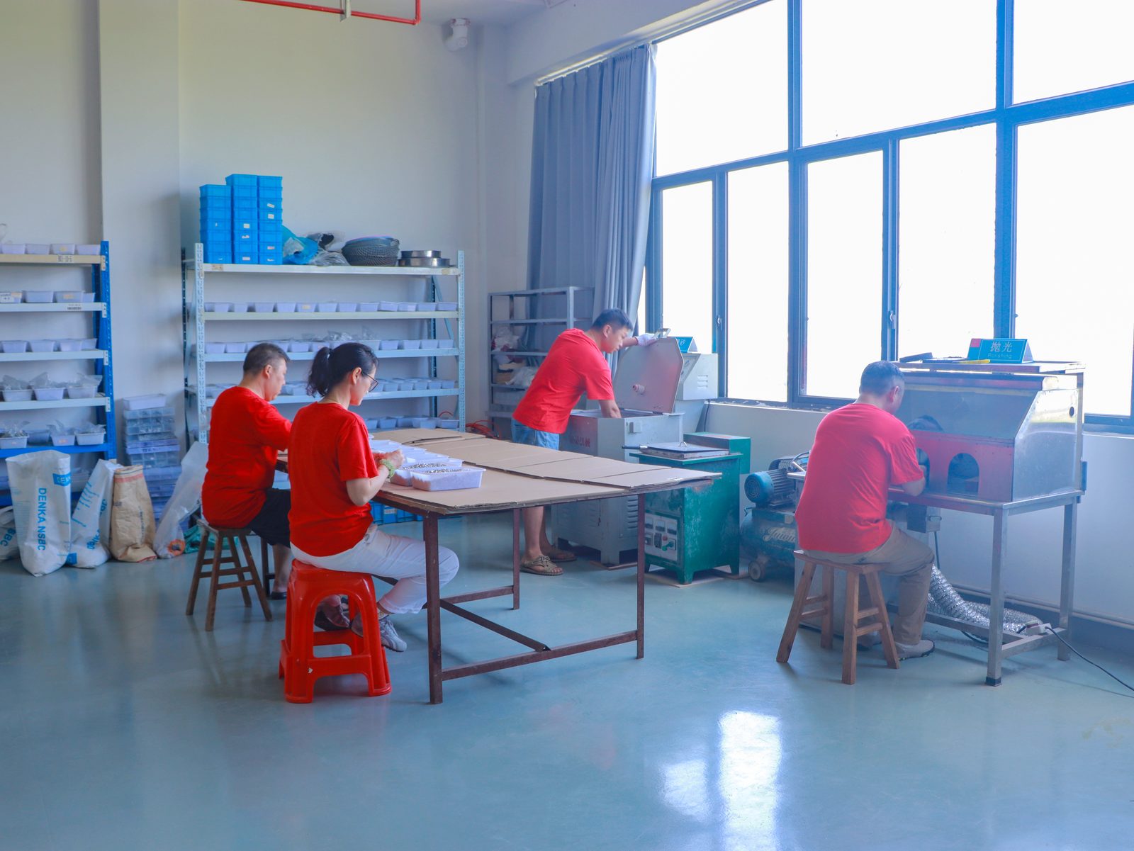 Polishing workshop — workers operating polishing machines for charm finishing